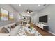 Open-concept living room with hardwood floors, stylish furniture, and abundant natural light at 5526 Lily Rd, Lakeland, FL 33811