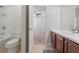 Bathroom with dark wood vanity and combination shower/tub at 7343 Derexa Dr, Windermere, FL 34786