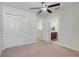 Spacious bedroom with ceiling fan and private bath access at 7343 Derexa Dr, Windermere, FL 34786