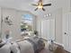 Cozy bedroom with an arched window, ceiling fan, and ample closet space at 1027 Sweetbrook Way, Orlando, FL 32828