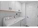 Bright laundry room, featuring washer, dryer, and ample cabinetry at 1027 Sweetbrook Way, Orlando, FL 32828