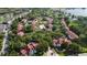 Aerial view of community with mature trees, pool, tennis courts and water view at 11538 Westwood Blvd # 226, Orlando, FL 32821