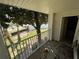 Private balcony overlooking a tree and grassy area at 11538 Westwood Blvd # 226, Orlando, FL 32821