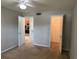 Bedroom with carpet flooring and open doors, one showing kitchen at 11538 Westwood Blvd # 226, Orlando, FL 32821