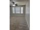 Bedroom with large windows, carpet, and ceiling fan at 11538 Westwood Blvd # 226, Orlando, FL 32821