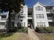 Two-story white building with multiple units and stairs at 11538 Westwood Blvd # 226, Orlando, FL 32821