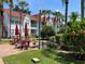 Relaxing community patio with red picnic tables and umbrellas at 11538 Westwood Blvd # 226, Orlando, FL 32821