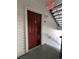 Red door entry to condo unit with nearby staircase at 11538 Westwood Blvd # 226, Orlando, FL 32821