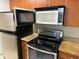 Close up on the kitchen appliances including an oven, microwave, and refrigerator at 11538 Westwood Blvd # 226, Orlando, FL 32821