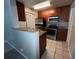 Galley kitchen with stainless steel appliances and granite countertops at 11538 Westwood Blvd # 226, Orlando, FL 32821