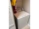 Convenient laundry area with a white top-load washing machine and fire extinguisher at 11538 Westwood Blvd # 226, Orlando, FL 32821