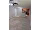 Inviting living room featuring neutral carpet, ceiling fan and an open layout to the kitchen at 11538 Westwood Blvd # 226, Orlando, FL 32821