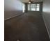 Large living area with neutral carpeting and sliding door access at 11538 Westwood Blvd # 226, Orlando, FL 32821