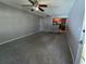 Open living room with neutral walls and carpet, kitchen view at 11538 Westwood Blvd # 226, Orlando, FL 32821