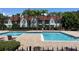 Community pool with plenty of lounge chairs at 11538 Westwood Blvd # 226, Orlando, FL 32821