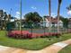 Community tennis court with green fencing at 11538 Westwood Blvd # 226, Orlando, FL 32821