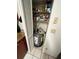 Interior utility closet featuring shelving and a hot water heater at 11538 Westwood Blvd # 226, Orlando, FL 32821