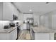 Modern kitchen with white cabinets, granite countertops, and stainless steel appliances at 12067 White Wave Pt, Orlando, FL 32828