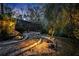 Landscaped backyard with stone pathway, lighting, and screened enclosure at 124 Adler Pt, Oviedo, FL 32765