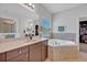 Elegant bathroom with soaking tub, double vanity, and walk-in shower at 124 Adler Pt, Oviedo, FL 32765