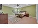 Relaxing bedroom with light walls, ceiling fan, and a large bed at 124 Adler Pt, Oviedo, FL 32765