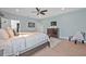 Spacious main bedroom with light blue walls, ceiling fan, and a large bed at 124 Adler Pt, Oviedo, FL 32765