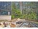 Stone fire pit area nestled in the backyard landscape at 124 Adler Pt, Oviedo, FL 32765