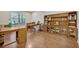 Functional home office with built-in wooden shelving and hardwood floors at 124 Adler Pt, Oviedo, FL 32765