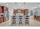 Well-equipped kitchen featuring dark wood cabinets and an island breakfast bar at 124 Adler Pt, Oviedo, FL 32765