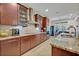 Modern kitchen featuring granite countertops, stainless steel appliances, and dark wood cabinets at 124 Adler Pt, Oviedo, FL 32765