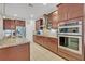 Eat-in kitchen boasts granite countertops, stainless steel appliances, and ample cabinet space at 124 Adler Pt, Oviedo, FL 32765