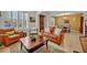 Spacious living room with leather armchairs, a coffee table, and a view of the dining area at 124 Adler Pt, Oviedo, FL 32765