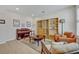 Cozy living room featuring a piano, built-in shelves, and comfy seating at 124 Adler Pt, Oviedo, FL 32765