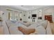 Spacious living room with large sectional sofa, built-in shelving, and access to backyard at 124 Adler Pt, Oviedo, FL 32765