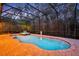 Inviting screened pool and spa at dusk at 124 Adler Pt, Oviedo, FL 32765