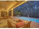 Relaxing screened patio with a pool, spa, and outdoor seating at 124 Adler Pt, Oviedo, FL 32765