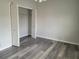 A bedroom with laminate flooring and an open closet at 155 N Pearl Lake Cswy # 200, Altamonte Springs, FL 32714