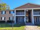 Exterior view of condo building with walkway and landscaping at 155 N Pearl Lake Cswy # 200, Altamonte Springs, FL 32714