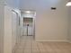 Bright laundry area featuring tiled floors, white walls, and a washing machine with dryer at 155 N Pearl Lake Cswy # 200, Altamonte Springs, FL 32714
