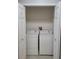 Laundry closet with white washer and dryer, wire shelving, and double doors at 155 N Pearl Lake Cswy # 200, Altamonte Springs, FL 32714