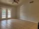 A living room with French doors, tile flooring, and a ceiling fan at 155 N Pearl Lake Cswy # 200, Altamonte Springs, FL 32714