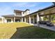 Expansive backyard featuring a covered patio and lush lawn at 20344 Sheldon St, Orlando, FL 32833