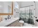 Bathroom with single vanity, shower/tub combo, and nature-themed decor at 20344 Sheldon St, Orlando, FL 32833