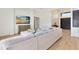Open living room featuring a large sectional sofa, wood-look floors, and a beautiful view from a large TV at 20344 Sheldon St, Orlando, FL 32833