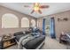 Bedroom with a bed, ceiling fan, and arched window at 2236 Sandridge Cir, Eustis, FL 32726