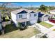 Two-story house with gray siding, solar panels, and a backyard at 236 Talisi Loop, St Cloud, FL 34771