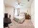 Bright bedroom with a queen-size bed, desk, and window at 236 Talisi Loop, St Cloud, FL 34771
