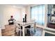 Dining room with gray table and white chairs, hardwood floors, and natural light at 236 Talisi Loop, St Cloud, FL 34771