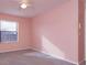 Light pink bedroom with window and ceiling fan at 2410 Alclobe Cir, Ocoee, FL 34761