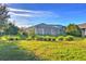 Large backyard with lush grass and screened patio at 2423 Hyatt Creek Ln, Port Orange, FL 32128